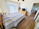 Bedroom with wood floors, ceiling fan, and sliding glass door to outdoor space at 1356 Glenns Bay Rd. # 201B, Surfside Beach, SC 29575