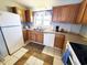 Well-lit kitchen features wood cabinets, stainless steel sink, and white appliances at 1356 Glenns Bay Rd. # 201B, Surfside Beach, SC 29575