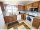 Bright kitchen with stainless steel microwave, white appliances, and wood cabinets at 1356 Glenns Bay Rd. # 201B, Surfside Beach, SC 29575