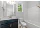 Bathroom with single sink vanity, window, and shower/tub combo at 19 Coventry Pl., Pawleys Island, SC 29585