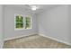 Bedroom featuring neutral carpet, white trim, ceiling fan, and large windows at 19 Coventry Pl., Pawleys Island, SC 29585