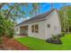 Well-maintained white home with verdant lawn and covered patio visible at 19 Coventry Pl., Pawleys Island, SC 29585