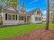 Charming white home showcasing manicured lawn with garden beds and a welcoming entrance at 19 Coventry Pl., Pawleys Island, SC 29585