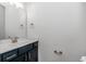 This half bathroom features a stylish dark vanity, modern fixtures, and clean, bright decor at 19 Coventry Pl., Pawleys Island, SC 29585