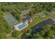 Aerial view of the community clubhouse, pool, tennis courts, and surrounding landscape at 192 Berkshire Loop, Pawleys Island, SC 29585
