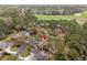 Aerial view of a home nestled amongst trees with a golf course in the distance at 192 Berkshire Loop, Pawleys Island, SC 29585