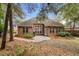Charming brick home exterior with a patio area, landscaped backyard, and grill at 192 Berkshire Loop, Pawleys Island, SC 29585