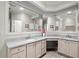 Bright bathroom featuring dual sinks, granite countertops, and large mirrors over a spacious vanity area at 192 Berkshire Loop, Pawleys Island, SC 29585