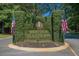 Entrance to Heritage Plantation with landscaped features and American flags at 192 Berkshire Loop, Pawleys Island, SC 29585