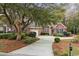 Beautiful brick home with lush landscaping, a curved driveway and mature trees at 192 Berkshire Loop, Pawleys Island, SC 29585