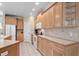 Spacious kitchen featuring light wood cabinetry, tile flooring, and modern appliances with ample counter space at 192 Berkshire Loop, Pawleys Island, SC 29585