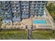Aerial view of a multi-story building with a pool, seating, and boardwalk access to the beach at 2001 S Ocean Blvd. # 621, Myrtle Beach, SC 29577