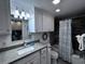 Cozy bathroom with granite counters, modern lighting, and a tub with shower curtain at 2001 S Ocean Blvd. # 621, Myrtle Beach, SC 29577