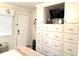 This bedroom features white cabinets with a TV, drawers, and a decorative nautical theme at 2001 S Ocean Blvd. # 621, Myrtle Beach, SC 29577
