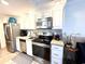 Well-lit kitchen has stainless steel appliances, granite counters and white cabinets at 2001 S Ocean Blvd. # 621, Myrtle Beach, SC 29577
