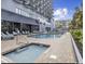 Exterior pool area featuring a hot tub, pool, lounge chairs, and patio space at 2001 S Ocean Blvd. # 621, Myrtle Beach, SC 29577