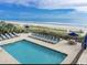 Beachside pool featuring lounge chairs, umbrellas, and ocean views on a clear day at 2001 S Ocean Blvd. # 621, Myrtle Beach, SC 29577