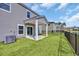 Backyard features a pond, grass, and a covered porch at 204 Leaflet Loop, Pawleys Island, SC 29585