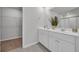 Modern bathroom features a double sink vanity, decorative tile flooring, and convenient access to a walk-in closet at 204 Leaflet Loop, Pawleys Island, SC 29585