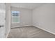 An empty, bright bedroom with carpet flooring, neutral walls, and a sunlit window at 204 Leaflet Loop, Pawleys Island, SC 29585