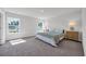 Bright bedroom with two windows, neutral walls, carpet, and stylish furnishings creating a serene retreat at 204 Leaflet Loop, Pawleys Island, SC 29585