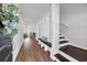 Welcoming entryway with a bench, coat hooks, and hardwood floors leading to stairs at 204 Leaflet Loop, Pawleys Island, SC 29585