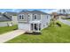 Charming two-story home with grey siding, white trim, two car garage, and manicured lawn at 204 Leaflet Loop, Pawleys Island, SC 29585