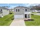 Charming two-story home with grey siding, white trim, two car garage, and manicured lawn at 204 Leaflet Loop, Pawleys Island, SC 29585
