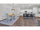 Open concept kitchen with white cabinetry, stainless appliances, a center island, and adjacent dining area at 204 Leaflet Loop, Pawleys Island, SC 29585