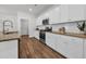 Bright kitchen with granite countertops, stainless steel appliances, and white cabinetry at 204 Leaflet Loop, Pawleys Island, SC 29585