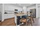 Stylish kitchen offers a central island with barstool seating, stainless appliances and granite countertops at 204 Leaflet Loop, Pawleys Island, SC 29585