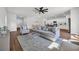Spacious living room with hardwood floors, neutral furniture, and an open floor plan with kitchen access at 204 Leaflet Loop, Pawleys Island, SC 29585