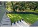 A well-maintained backyard featuring a lawn, privacy fence, and a patio with potted plants at 224 Oak Bay Dr., Georgetown, SC 29440