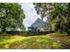 Spacious backyard features a two-story home and a dark, wooden fence at 224 Oak Bay Dr., Georgetown, SC 29440