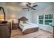 Bright bedroom features a wooden bed frame, wood floors, and a ceiling fan at 224 Oak Bay Dr., Georgetown, SC 29440