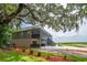 Beautiful raised home with mature trees, large yard, and ample parking space; lovely outdoor living at 224 Oak Bay Dr., Georgetown, SC 29440