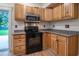 Well-lit kitchen features granite countertops, wood cabinets, and stainless steel appliances at 224 Oak Bay Dr., Georgetown, SC 29440