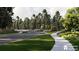 Scenic community entrance featuring lush landscaping, a curving road, and mature trees at 246 River Edge Dr., Myrtle Beach, SC 29588
