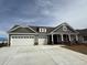 Charming single-Gathering home featuring a 3 car garage, gray siding, and a welcoming front porch at 246 River Edge Dr., Myrtle Beach, SC 29588