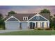 Charming two-story home with a three-car garage, blue siding, and a covered porch at 246 River Edge Dr., Myrtle Beach, SC 29588