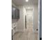 A long hallway with access to other rooms and gray cabinetry and light oak floors at 246 River Edge Dr., Myrtle Beach, SC 29588