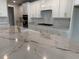 Modern kitchen featuring white cabinets, a marble countertop island, and stainless steel appliances at 246 River Edge Dr., Myrtle Beach, SC 29588