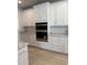 Modern kitchen featuring white cabinets, stainless steel appliances, and stylish backsplash at 246 River Edge Dr., Myrtle Beach, SC 29588
