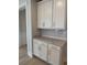 Kitchen featuring white cabinets, gold hardware, and marble countertop with backsplash at 246 River Edge Dr., Myrtle Beach, SC 29588
