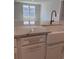 Close up of a white farmhouse sink and gold faucet on a kitchen marble countertop at 246 River Edge Dr., Myrtle Beach, SC 29588