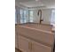 Close up of a white farmhouse sink and gold faucet on a marble kitchen island at 246 River Edge Dr., Myrtle Beach, SC 29588