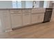 Kitchen island featuring a white undermount sink, gold faucet, and stainless steel dishwasher at 246 River Edge Dr., Myrtle Beach, SC 29588