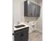 Well-lit laundry room featuring gray cabinets and gray floor tiling and chrome hardware at 246 River Edge Dr., Myrtle Beach, SC 29588