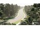 Overhead street view featuring lush landscaping, a sidewalk, and mature trees at 246 River Edge Dr., Myrtle Beach, SC 29588
