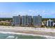 Aerial view of high-rise condos, beach, and ocean on a sunny day at 2801 S Ocean Blvd. # 231, North Myrtle Beach, SC 29582